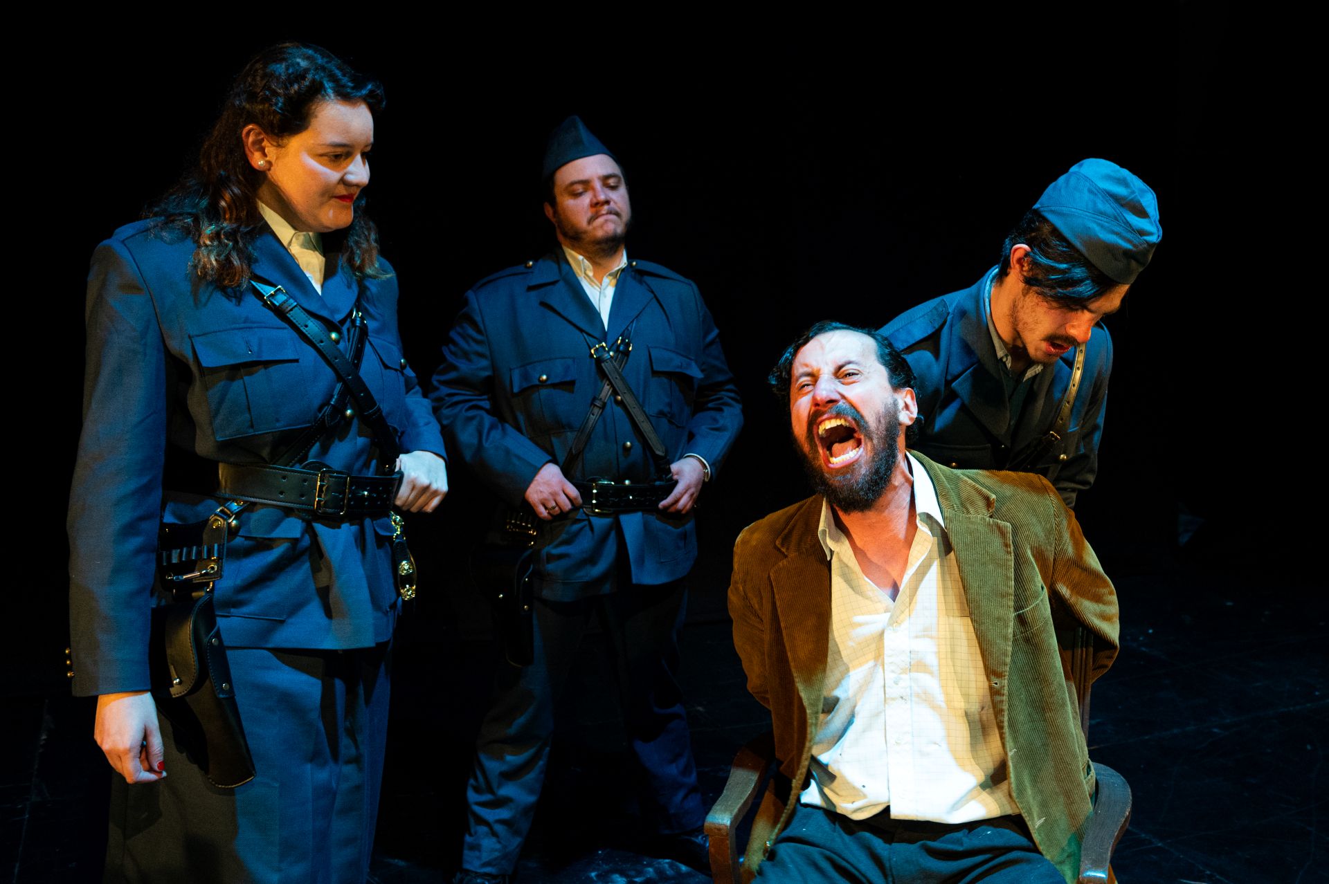 Escena de "Muertos sin sepultura" en el Teatro Libre: momento de confrontación entre milicianos colaboracionistas y un prisionero de la Resistencia, mostrando los dilemas morales que plantea Jean-Paul Sartre.